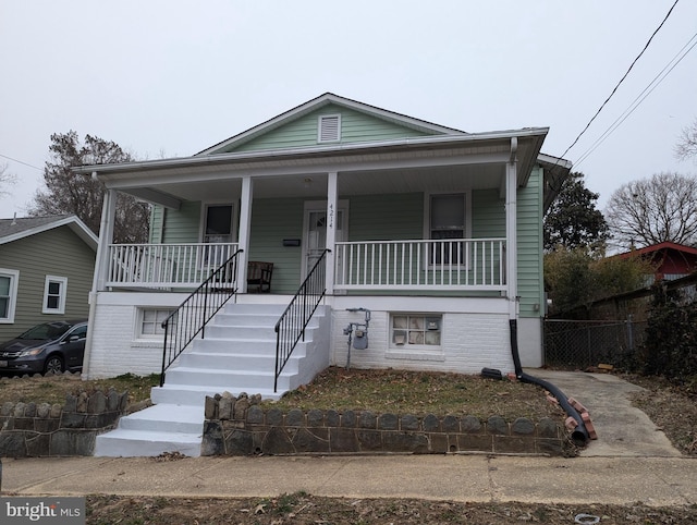 view of front facade with a porch and fence