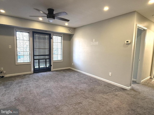 carpeted spare room featuring recessed lighting, a ceiling fan, and baseboards