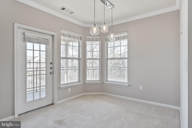 unfurnished dining area with visible vents, carpet flooring, baseboards, and ornamental molding