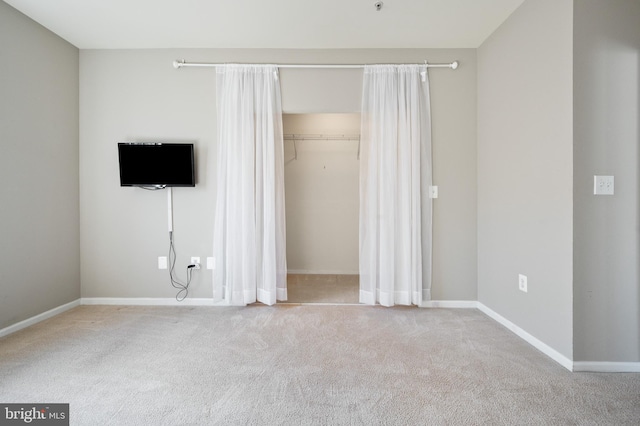 unfurnished bedroom with carpet flooring, baseboards, and a closet