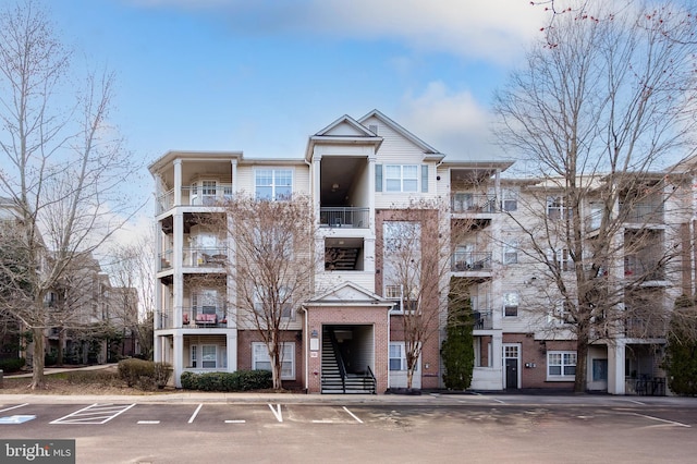 view of property featuring uncovered parking