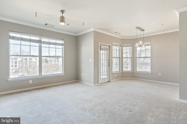 unfurnished room with plenty of natural light, light colored carpet, and crown molding