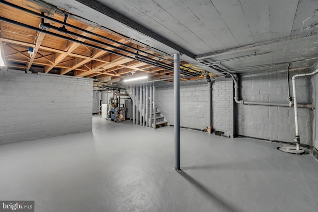 unfinished basement featuring stairs