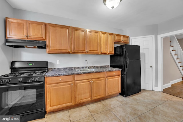 kitchen featuring a sink, under cabinet range hood, black appliances, and light tile patterned floors