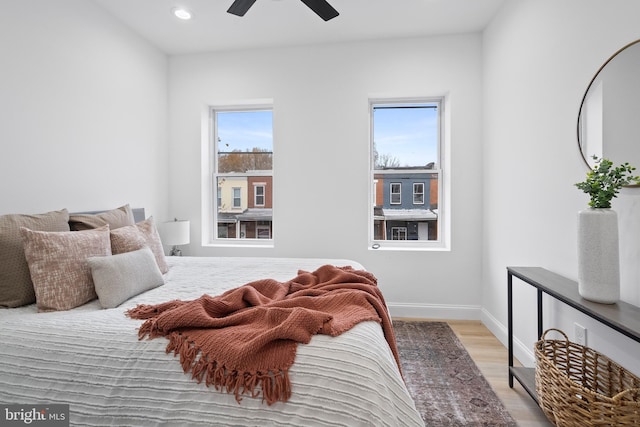 bedroom featuring baseboards, light wood-style flooring, recessed lighting, and a ceiling fan