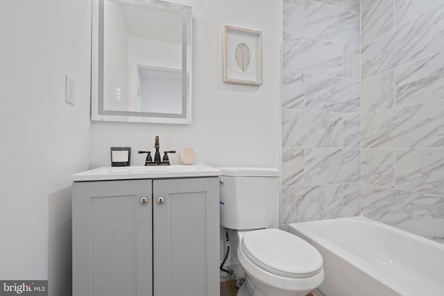 bathroom with toilet, vanity, and shower / tub combination