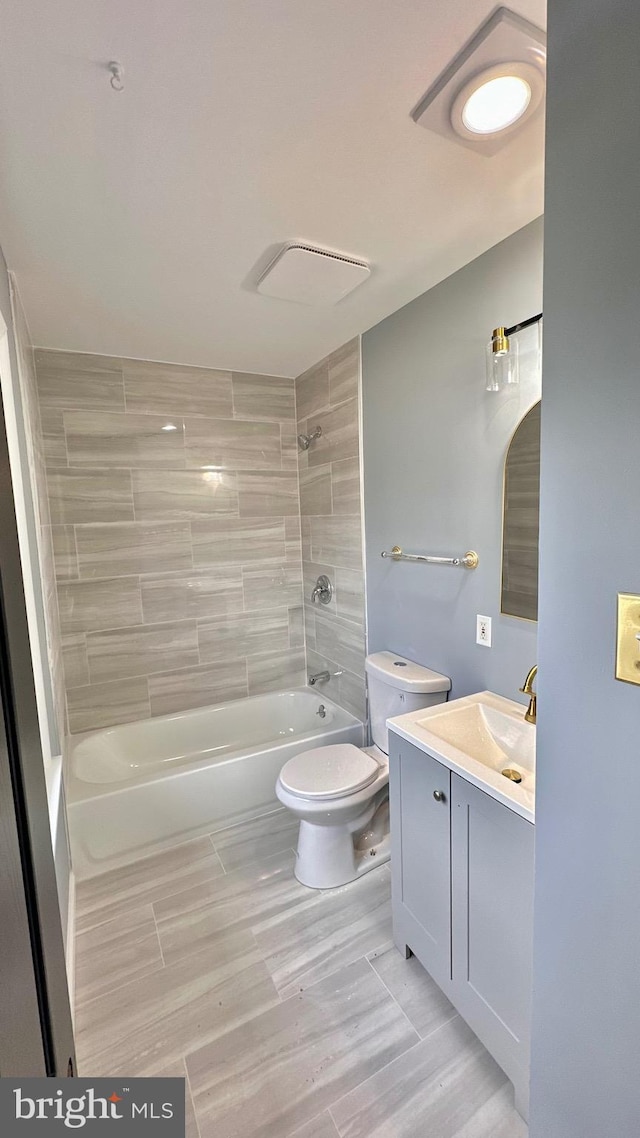 bathroom with toilet, vanity, visible vents, and shower / bathing tub combination