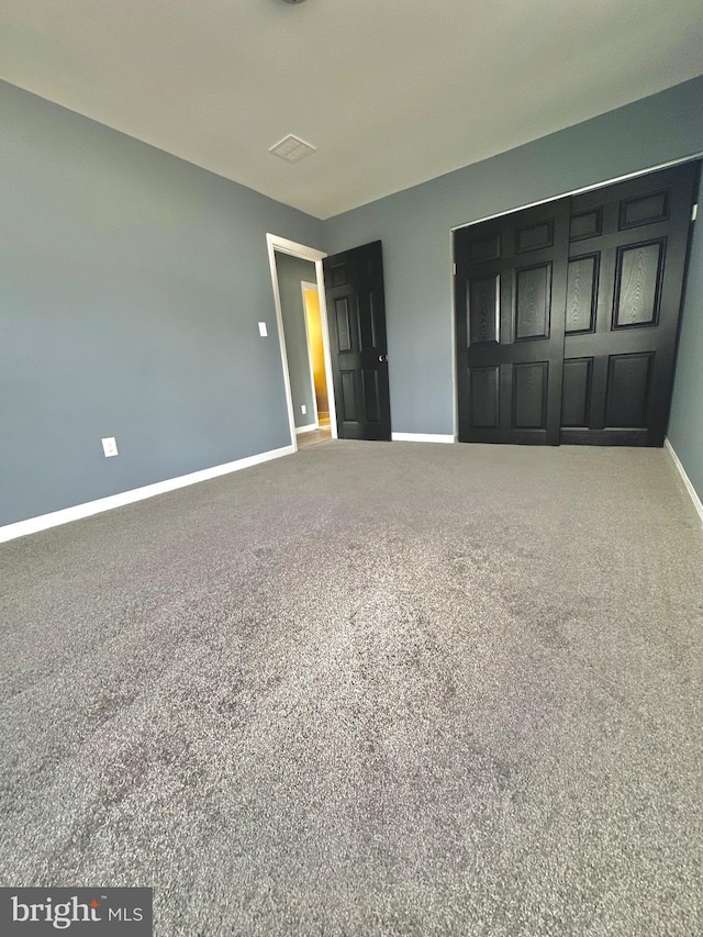 unfurnished bedroom featuring baseboards and carpet flooring