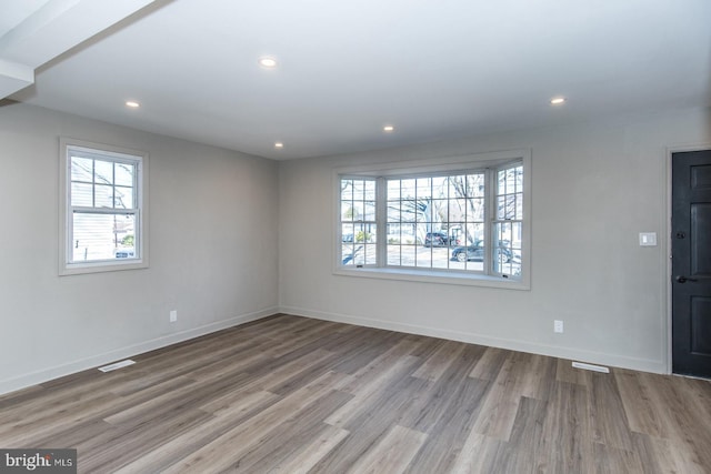 interior space featuring a healthy amount of sunlight, visible vents, wood finished floors, and recessed lighting