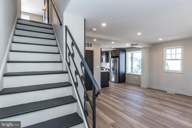 stairs with recessed lighting, visible vents, baseboards, and wood finished floors