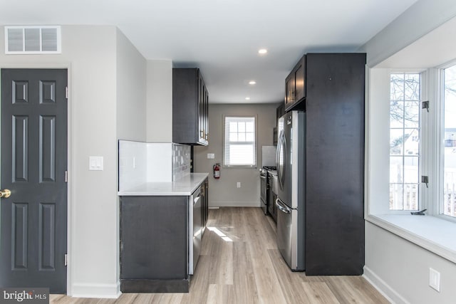 kitchen featuring visible vents, baseboards, light countertops, appliances with stainless steel finishes, and light wood-type flooring