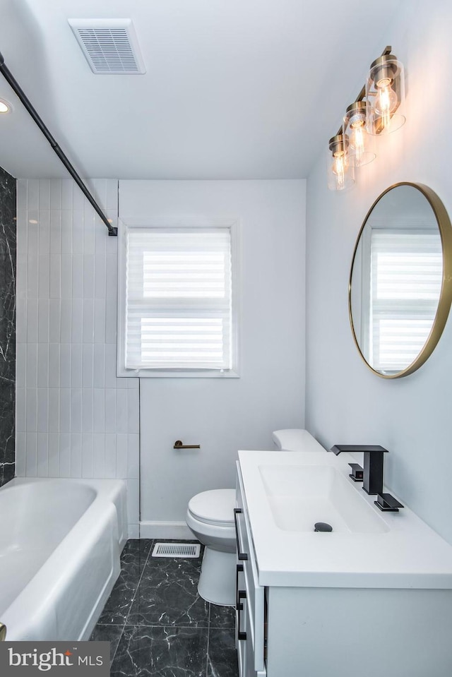 bathroom with a healthy amount of sunlight, marble finish floor, and visible vents