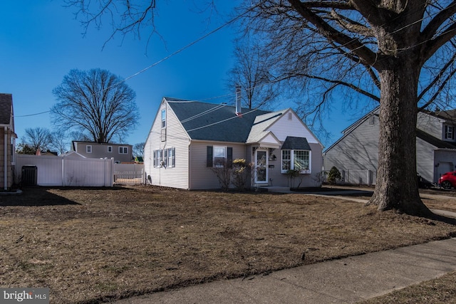 view of front of house featuring central AC unit and fence