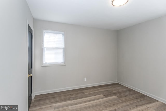 empty room featuring light wood-style floors and baseboards