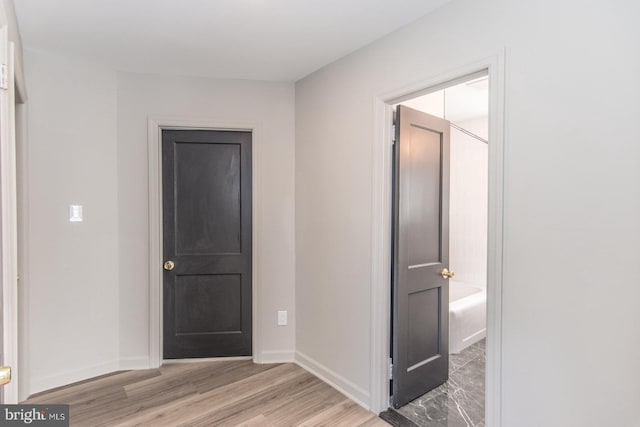 interior space with light wood-style floors and baseboards