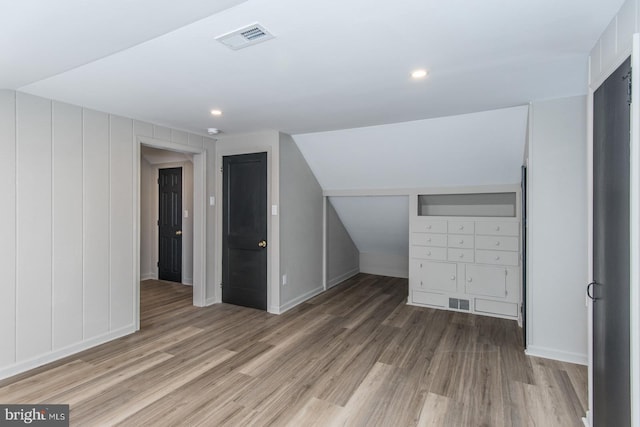 additional living space featuring baseboards, visible vents, wood finished floors, and recessed lighting