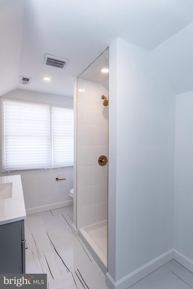 bathroom featuring toilet, marble finish floor, visible vents, and baseboards