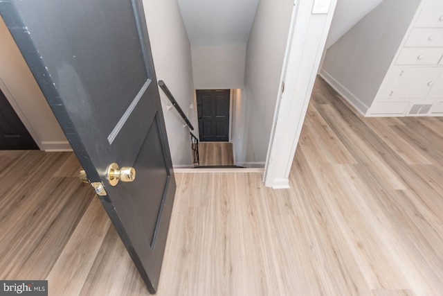 interior space featuring baseboards and wood finished floors