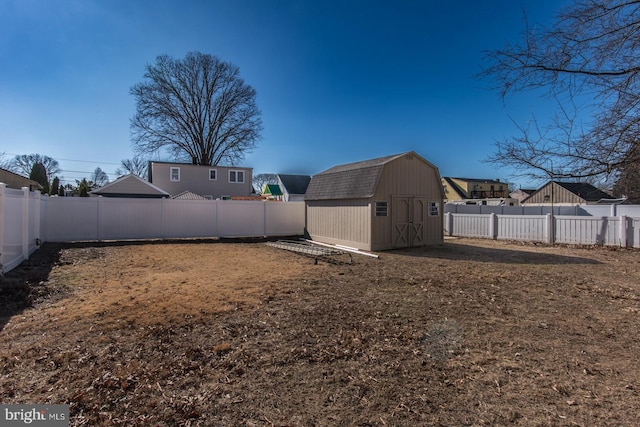 view of yard featuring a fenced backyard, an outdoor structure, and a storage unit