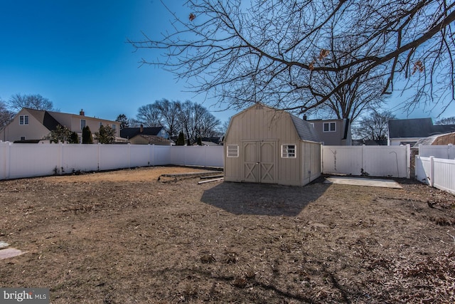 view of yard featuring a fenced backyard, an outdoor structure, and a storage shed