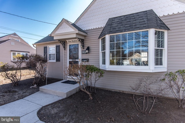 view of front of house with roof with shingles