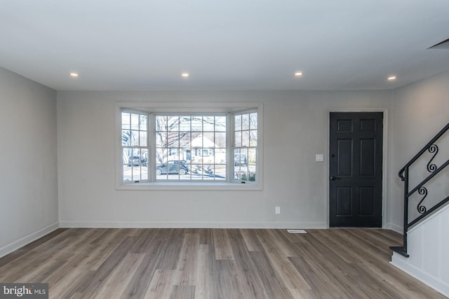 foyer featuring stairs, recessed lighting, baseboards, and wood finished floors