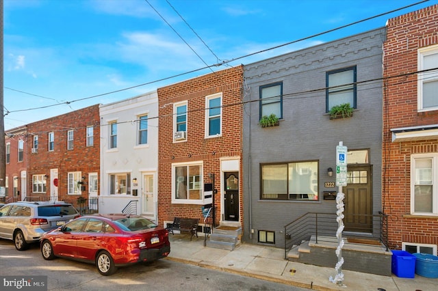 multi unit property featuring brick siding and entry steps