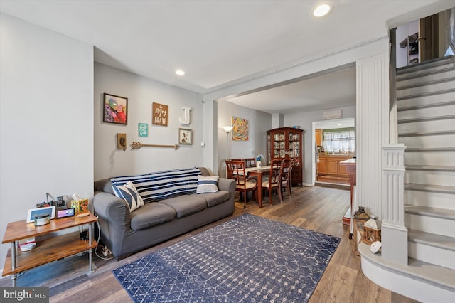 living area with stairway, recessed lighting, and wood finished floors