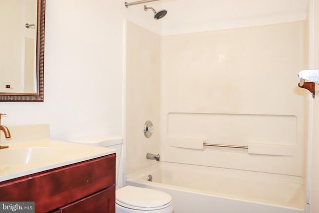 bathroom with tub / shower combination, vanity, and toilet