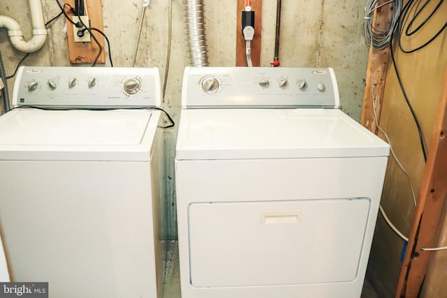 clothes washing area featuring laundry area and washer and clothes dryer