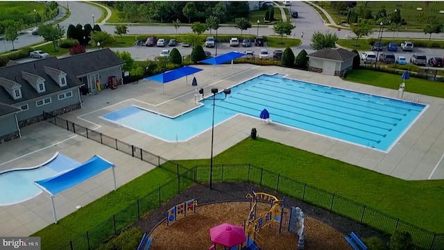 pool with a yard, fence, and a patio