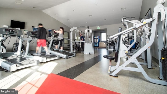 workout area featuring lofted ceiling and visible vents