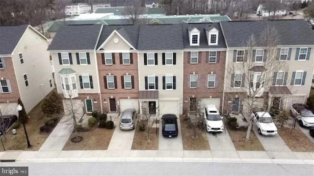 view of front of home with driveway and a residential view