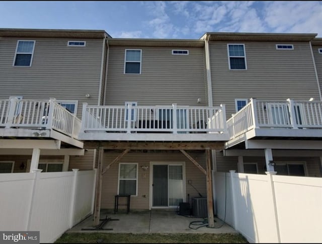 back of house featuring central AC, a patio, a deck, and fence