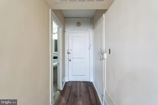 hall with dark wood-style floors and visible vents