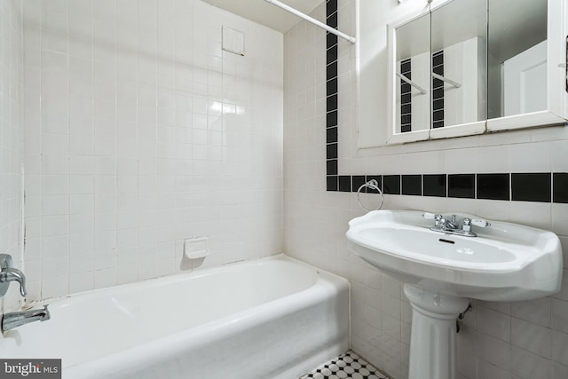 full bathroom featuring tile walls