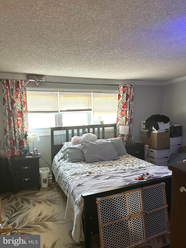 carpeted bedroom featuring a textured ceiling and crown molding