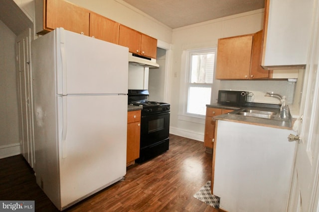 kitchen with black appliances, ornamental molding, a sink, under cabinet range hood, and dark wood-style flooring