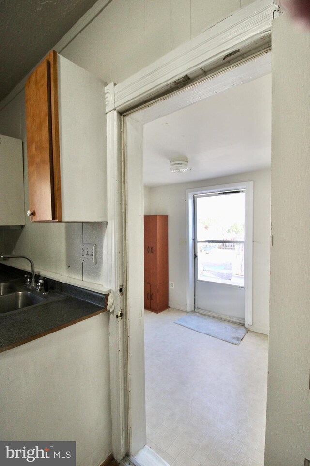 kitchen featuring dark countertops and a sink