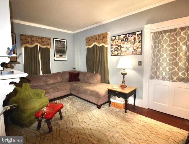 living room with crown molding, baseboards, and wood finished floors