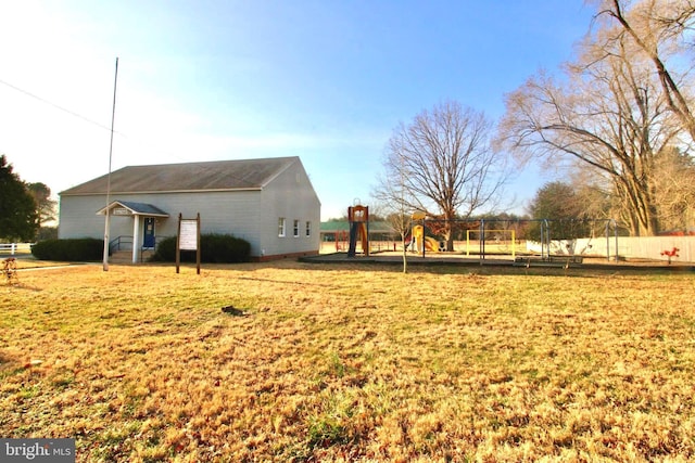 view of yard with a playground and fence