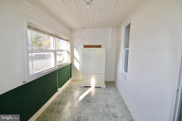 unfurnished sunroom with wood ceiling