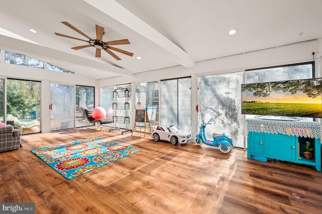 workout area featuring a ceiling fan, lofted ceiling, recessed lighting, and wood finished floors