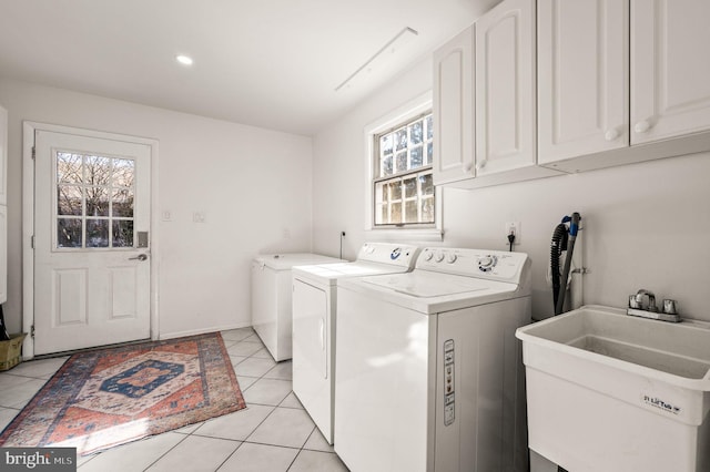 laundry area featuring cabinet space, light tile patterned floors, washer and clothes dryer, a sink, and recessed lighting