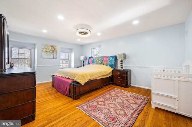 bedroom with recessed lighting, baseboards, and wood finished floors