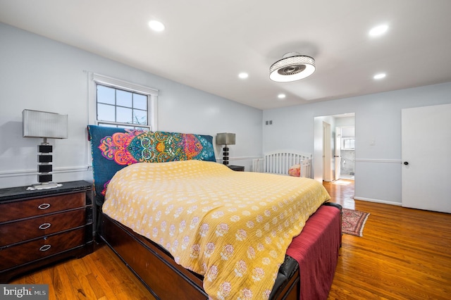 bedroom with recessed lighting and wood finished floors