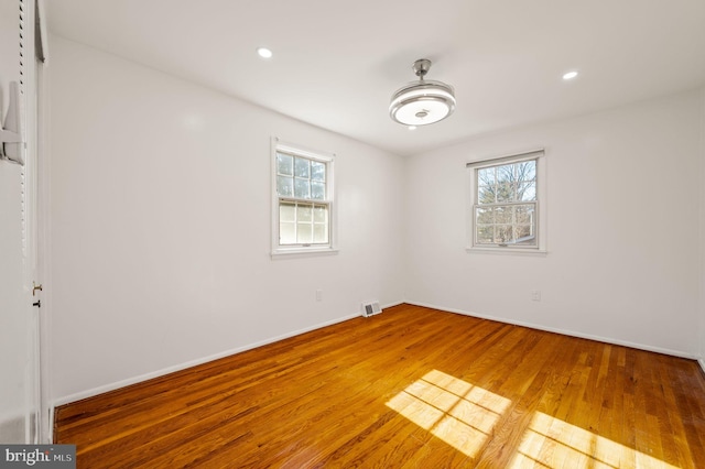 interior space featuring recessed lighting, plenty of natural light, baseboards, and wood finished floors