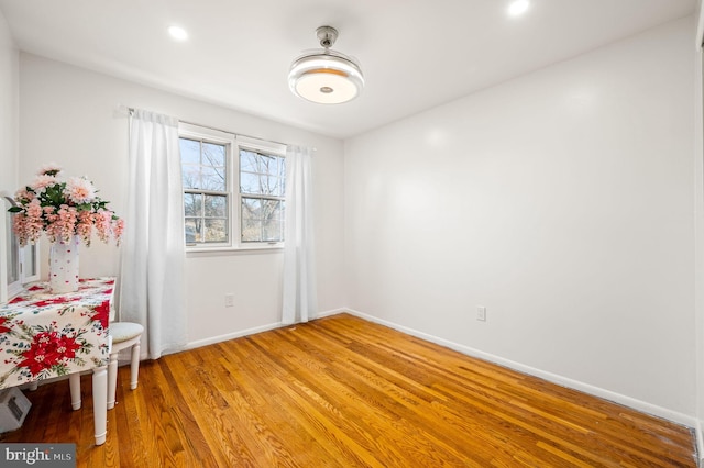 unfurnished room with light wood-style floors, baseboards, and recessed lighting