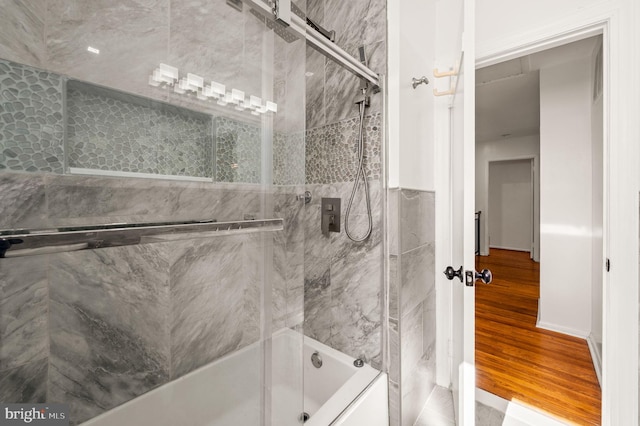 full bathroom with shower / bath combination with glass door and wood finished floors