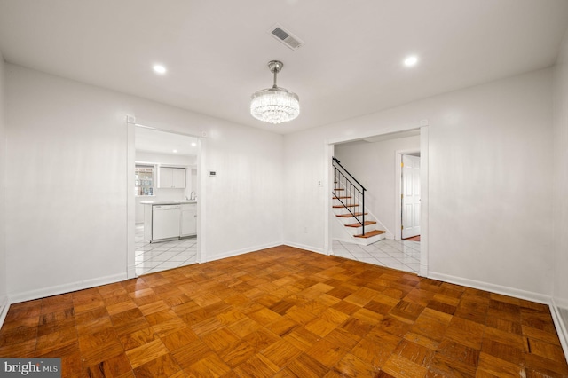 unfurnished room featuring a chandelier, recessed lighting, visible vents, baseboards, and stairway